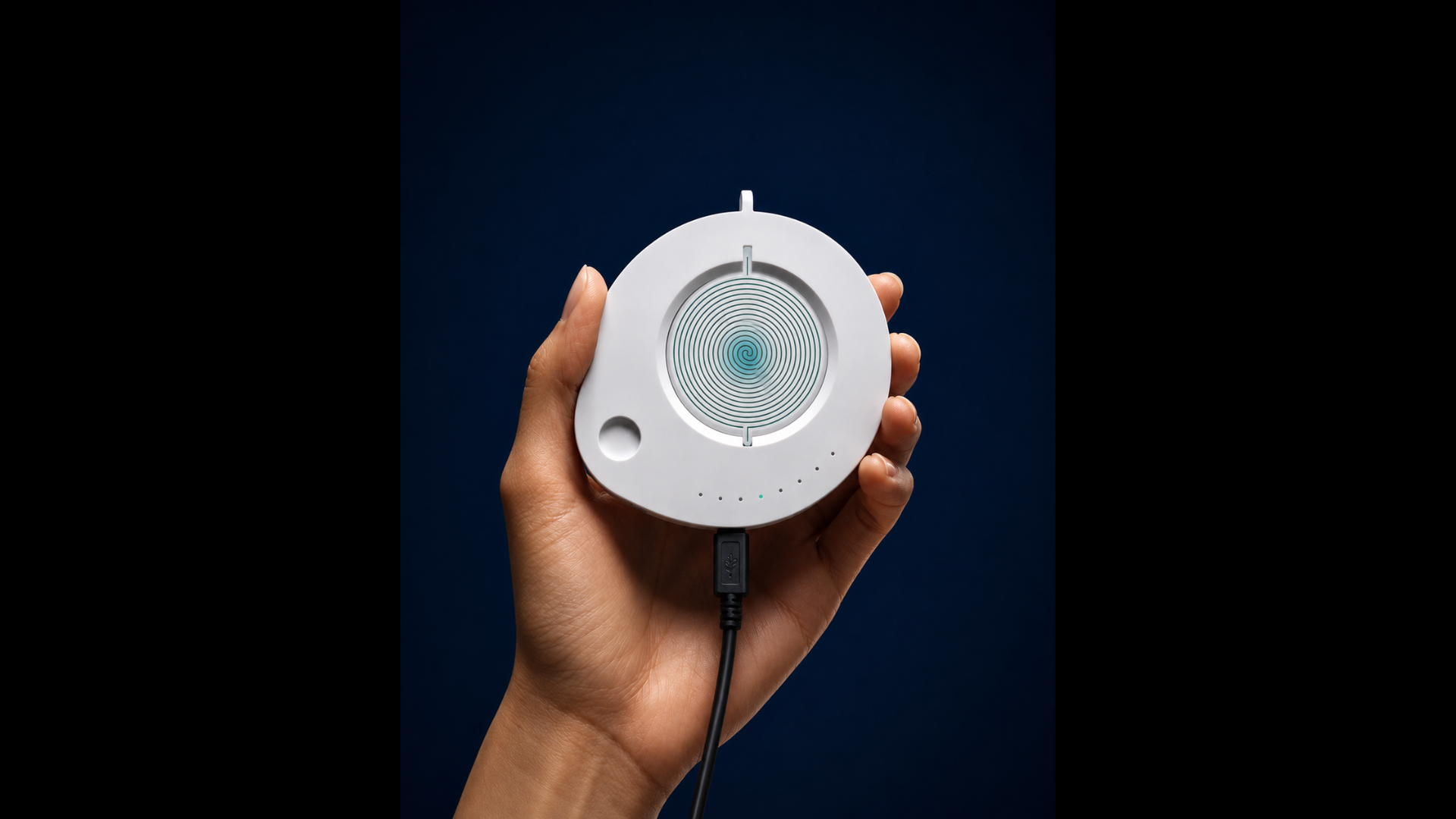 Hand holding a white circular Neuro20 recovery device with concentric rings and a charging cable, navy blue background, product photography.